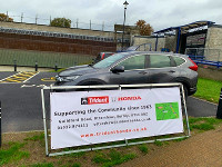 Trident Honda banner with Honda CR-V outside Woking Pool in the Park