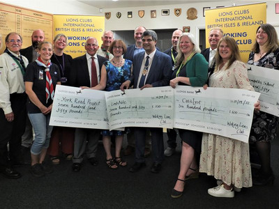 Cheques handover ceremony including the Mayor of Woking and Trident Honda director James Roberts