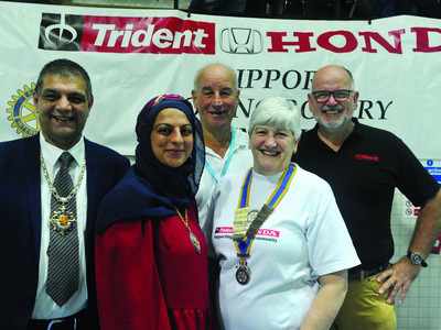 (From left) The Mayor of Woking, Cllr Saj Hussain, and his Mayoress, daughter Faaria, event organiser Terry Smith, Woking Rotary Club President Sue Jackson and Richard Roberts of Trident Honda Ottershaw. (Image courtesy of Woking News & Mail.)