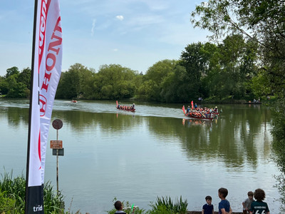 Spectators watching the dragon boats race across Goldsworth Park lake