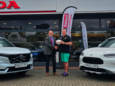 Richard Roberts, Managing Director of Trident Honda, presents 50 Gilbert rugby balls to Weybridge Vandals Club President, Kev Keaney.