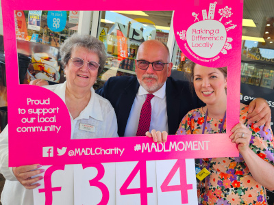Mary Spicer (Forecourt Manager), Richard Roberts (Managing Director) and Lucy McNally (Woking & Sam Beare Hospice)